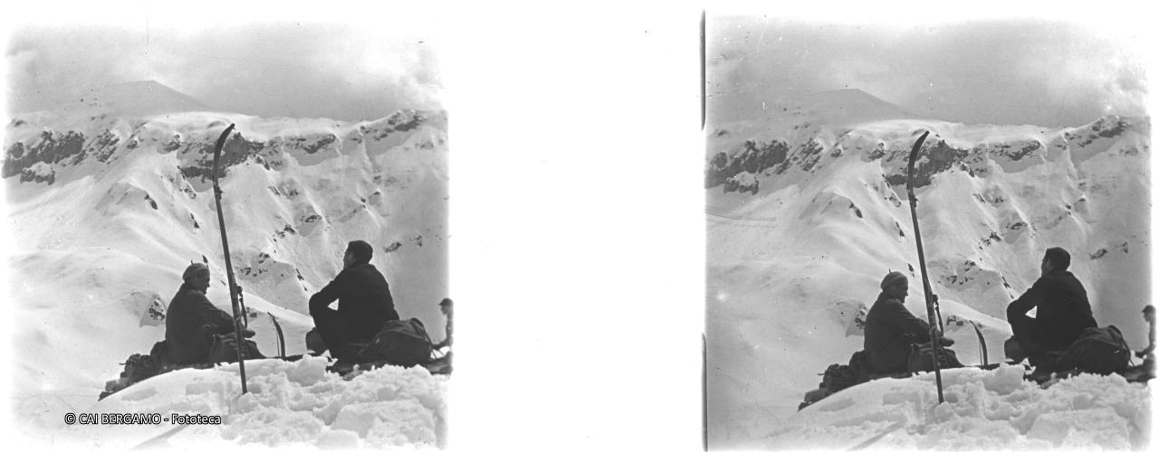 Sciatori seduti con sguardo verso valle …..